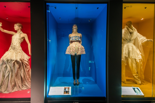 Three outfits from the museum's Dress of the Year collection on display