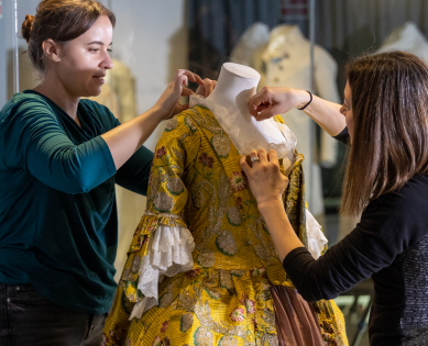 Collections team dressing a mannequin