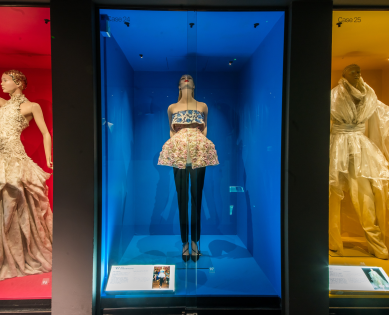 Three outfits from the Dress of the Year collection on display